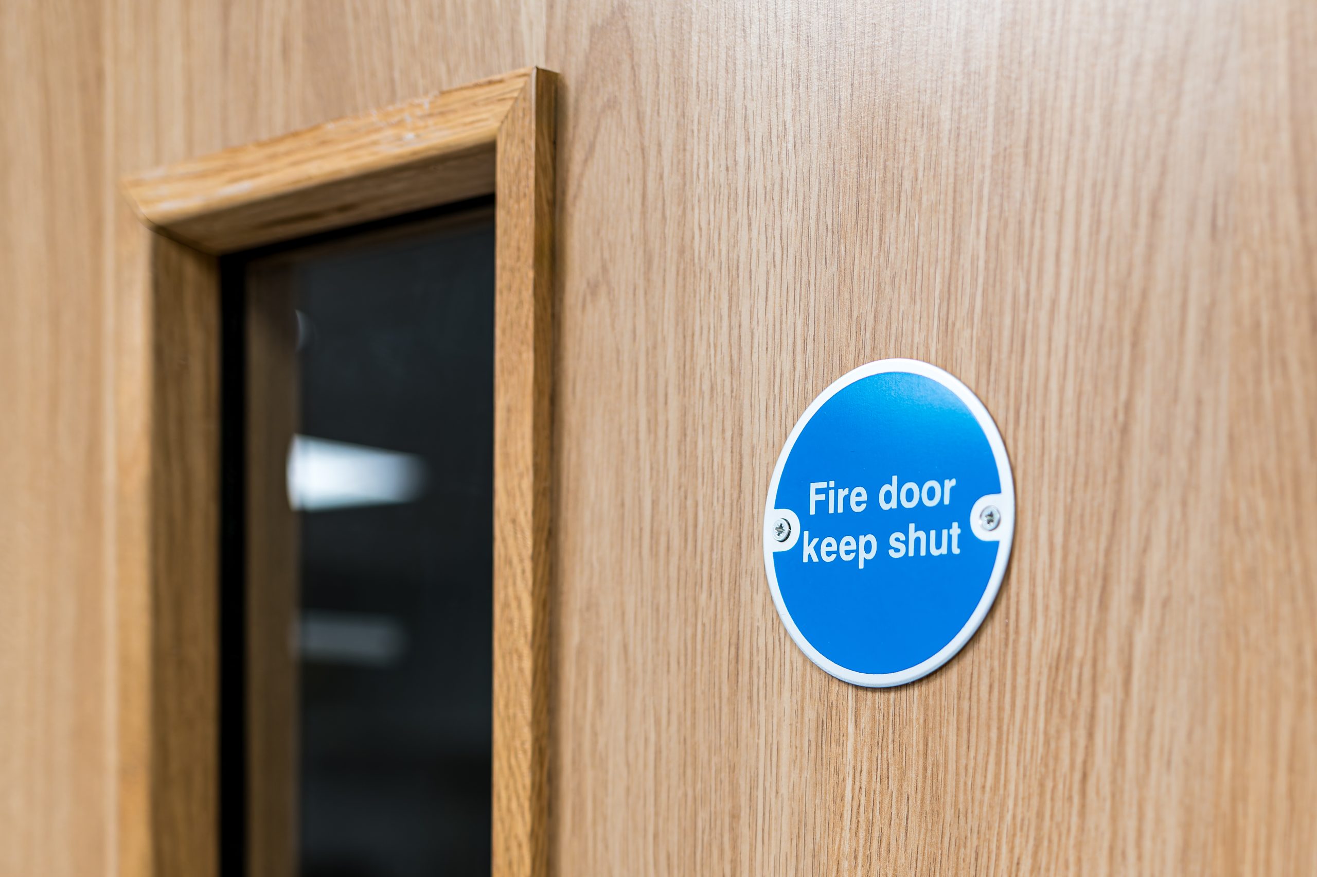 Fire door with keep shut safety sign