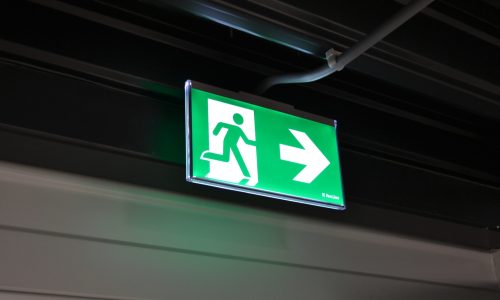 An emergency exit light telling staff where to go in case of an emergency and how to leave the building in case of fire
