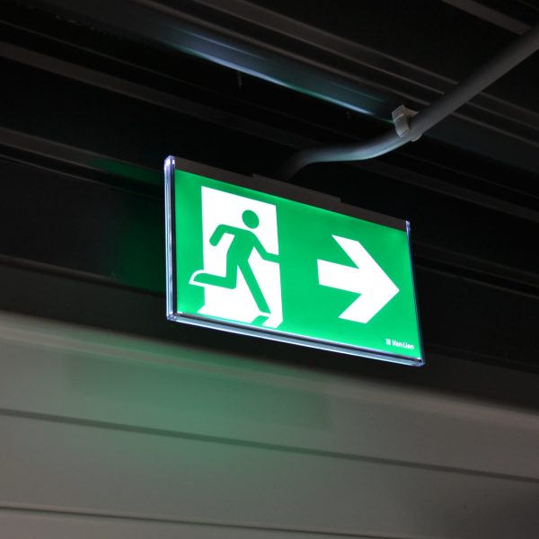 An emergency exit light telling staff where to go in case of an emergency and how to leave the building in case of fire